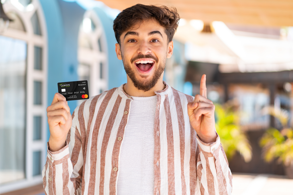 Happy young adult with credit card in hand